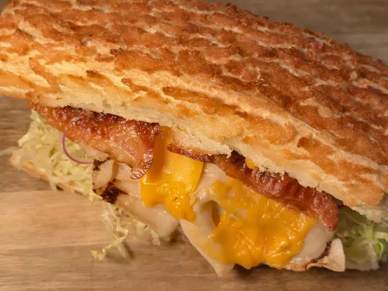 The 49er on a Dutch crunch roll, layered with sliced turkey, bacon, melted cheddar, shredded iceberg lettuce and red onion.